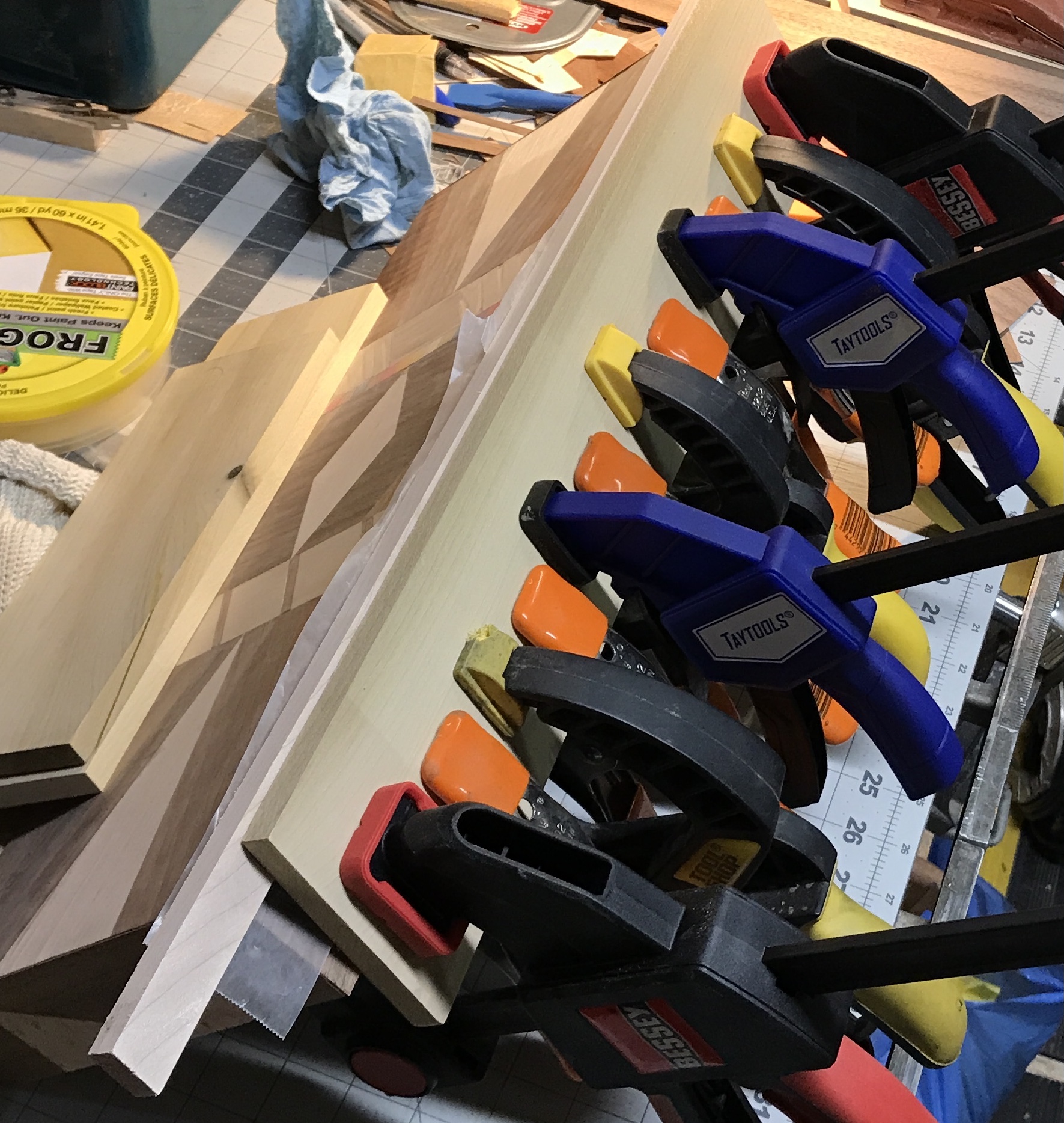 Clamping a strip of veneer to the edge of the box.